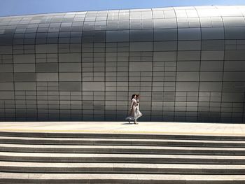 Woman in front of building