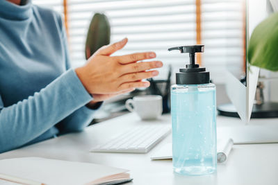 Close-up of person holding camera on table