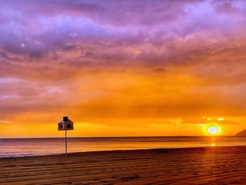 Scenic view of sea against orange sky