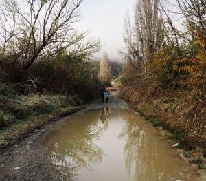 Father and child walking on footpath