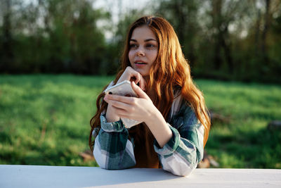 Young woman using mobile phone