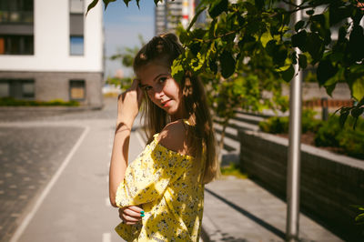 Portrait of young woman standing outdoors