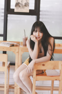 Portrait of young woman sitting on chair