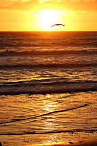 Scenic view of sea against romantic sky at sunset