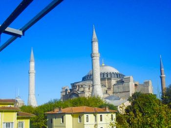 Low angle view of built structure against clear blue sky