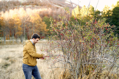 Portrait of young man standing in forest