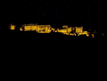 Illuminated building against sky at night