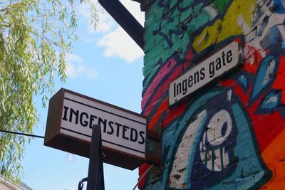 Low angle view of sign against sky