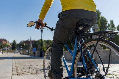 Unrecognizable man riding bicycle in the city