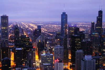 Aerial view of city lit up at night