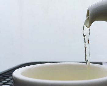 Close-up of water being poured in cup