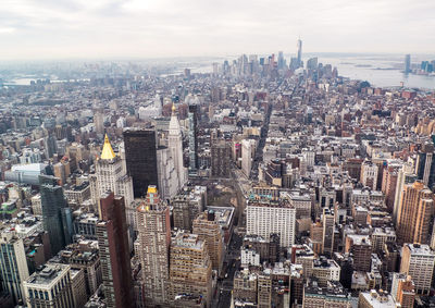 High angle view of modern buildings in city against sky