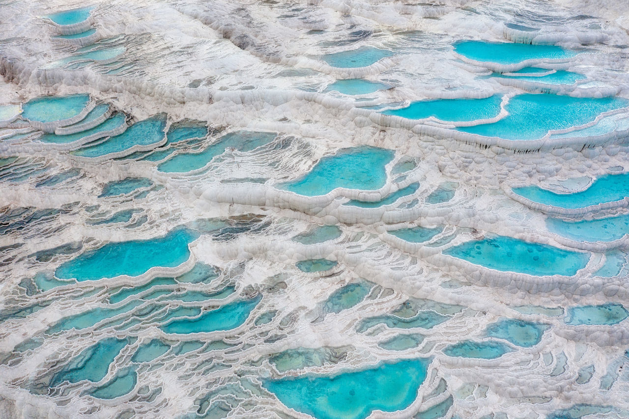 HIGH ANGLE VIEW OF BLUE WATER ON ICE