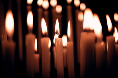 Close-up of lit candles in temple