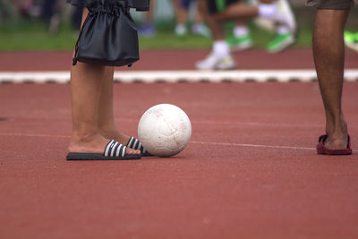 Low section of man playing with ball