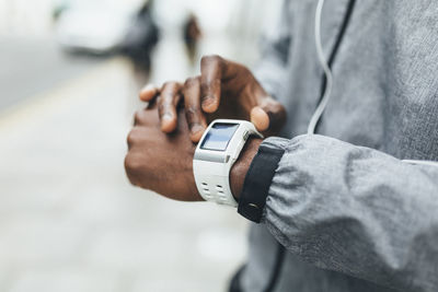 Close-up of athlete using smartwatch