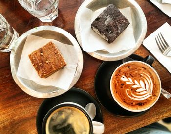 High angle view of coffee and cookies on table