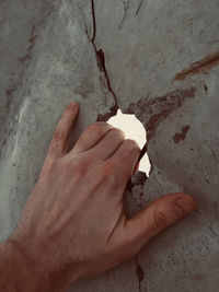 High angle view of person hand on wall