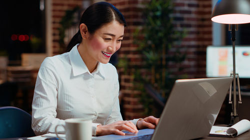 Young woman using laptop at office