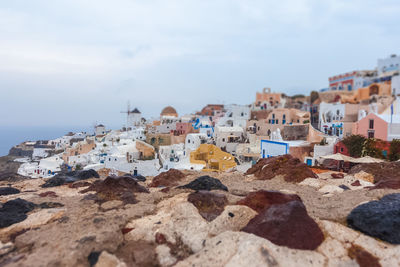 Tilt shift effect of oia village panorama on a rare rainy day, santorini, greece