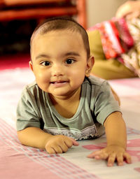 Portrait of cute baby lying at floor