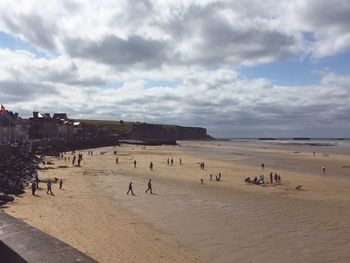 View of beach against cloudy sky