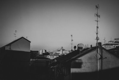 Buildings in city against clear sky