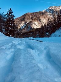 Snow covered mountain against blue sky