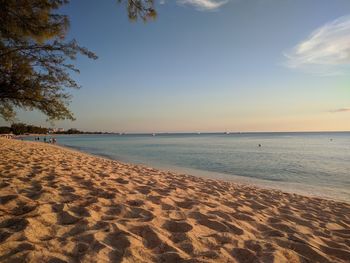 Scenic view of beach against sky during sunset