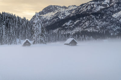 Snow covered landscape against sky