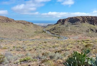 Scenic view of land and sea against sky