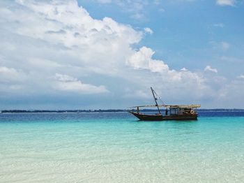 Fishing boat on sea against sky