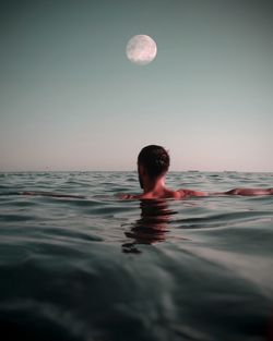 Portrait of woman swimming in sea