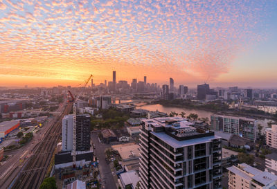 High angle view of buildings in city during sunset