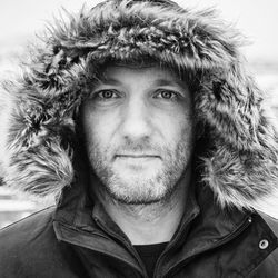 Close-up portrait of man wearing fur hood