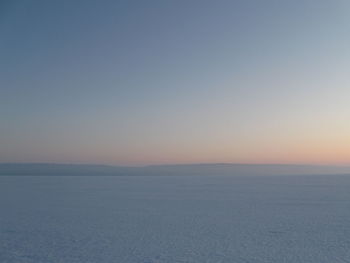 Scenic view of sea against clear sky during sunset