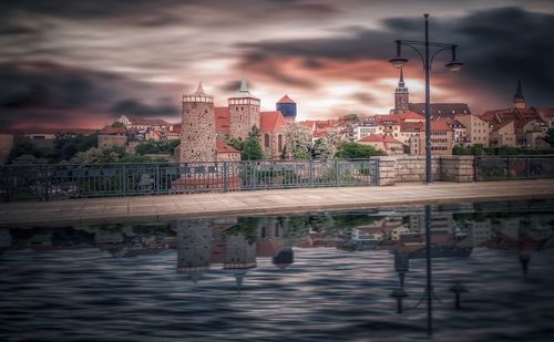 Bridge over river with buildings in background