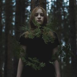 Woman standing in forest