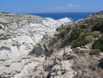 Scenic view of sea and mountains against sky