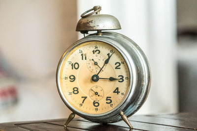 Close-up of clock on table