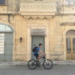 Man riding bicycle on building