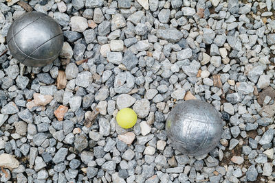 Petanque balls and the yellow wood jack on the ground