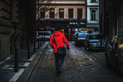 Rear view of man walking on street