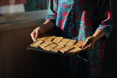 Midsection of woman holding food