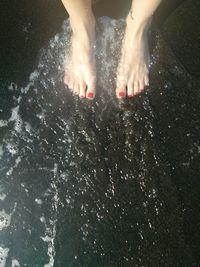 Low section of woman in water