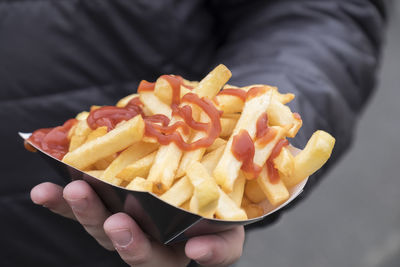 Close-up of hand holding fries