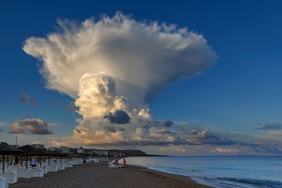 Scenic view of sea against cloudy sky during sunset