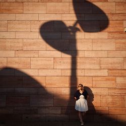 Woman standing by shadow