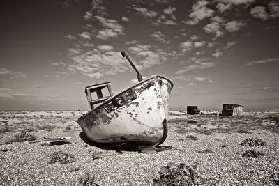 Abandoned boat on shore