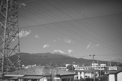 Aerial view of buildings and mountains against sky